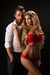 Photo of a young couple in sensual lingerie and suit