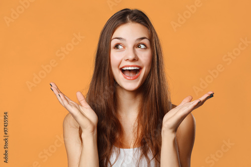 Fotografie, Obraz Surprised happy beautiful woman looking sideways in excitement