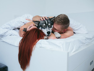 Poster - Young adult couple lying on bed