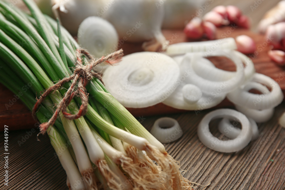Composition of onions and garlic on wooden background