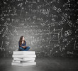 © ImageFlow - woman sitting on a pile of books thinking about problem
