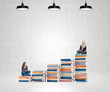 © ImageFlow - two young women sitting books thinking about future, dreaming