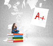 © ImageFlow - young woman on  pile of books with paper flying around