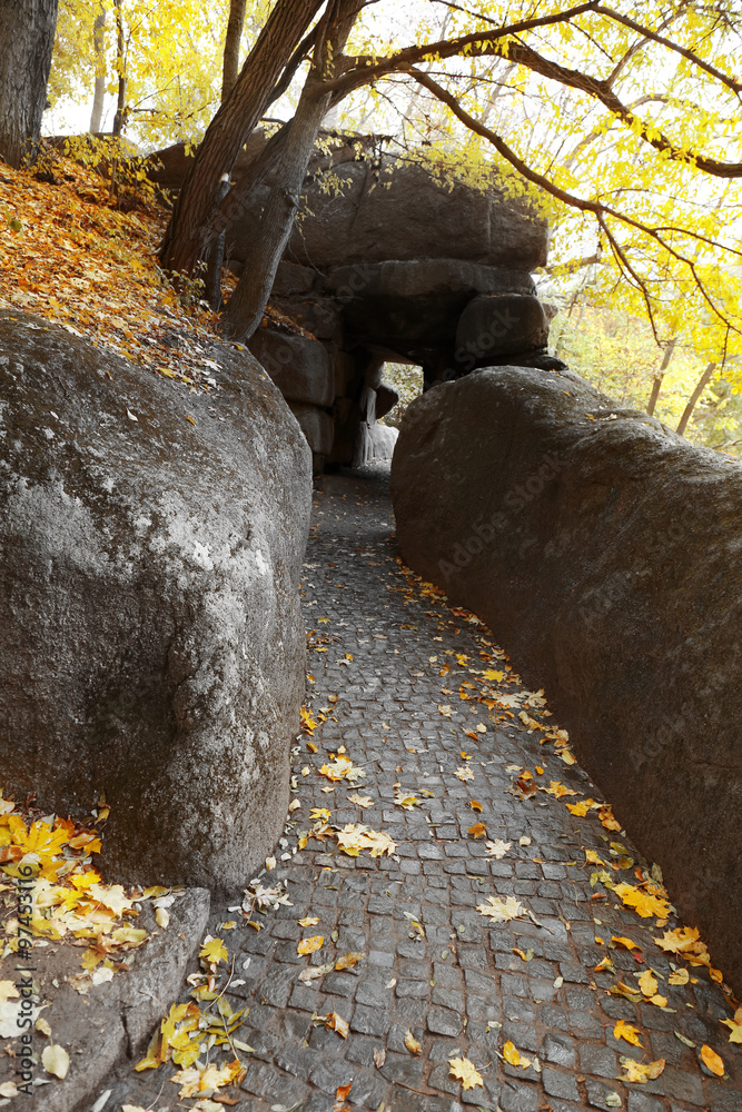 Stone corridor in the autumn park