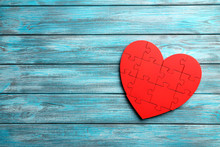 Red Puzzle Heart On Blue Wooden Background