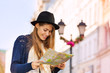 © Sergey Novikov - Cute beautiful girl with hat holding city map