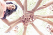 © Marino Bocelli - group of young adult putting their hands together in circle