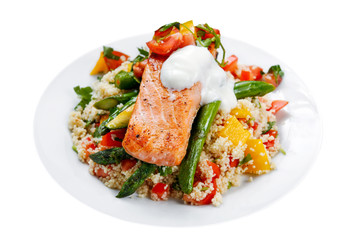 Wall Mural - Pan fried Salmon with tender asparagus, courgette served on couscous mixed with sweet tomato, yellow pepper, with greek yogurt, isolated on white