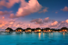 Water Bungalows With Beautiful Twilight Sky And Sea In Maldives. Long Exposure.