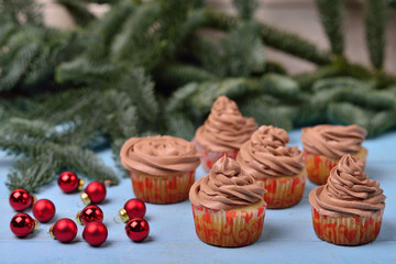 cupcakes with chocolate cream on a blue wooden background with r