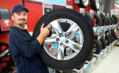 Wall Mural - Car mechanic with a tire.