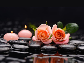 Beautiful orange rose with two candle and therapy stones 