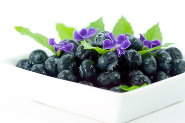 Blueberries with leaves on white background