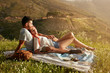 © Jacob Lund - Couple relaxing at picnic on a summer day