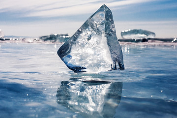 A large piece of ice on the surface of transparent frozen Lake B