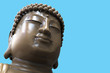 Close up of giant Buddha face on blue background