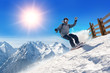 © guruXOX - Snowboarder freerider / Snowboarder man holding snowboard in the air jumping with mountains on background