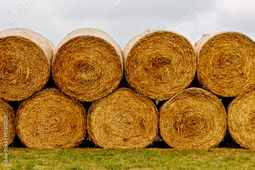 Fotografia, Obraz Hay bales on the field after harvest. A stack of hay.