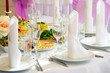 © maestrovideo - Festive table. Table setting. Festive round table with food.  Starched napkins and Cutlery. Festive meals. The restaurant inside. Service holidays. Design of the hall.