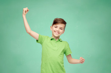 Poster - happy school boy in t-shirt showing strong fists