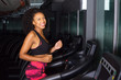 young woman running on a treadmill in the gym