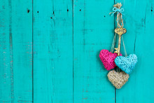 Skeleton Key And Three Rope Hearts Hanging On Door