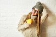 Romantic Dreaming Hipster Girl in Winter Clothes with a Mug