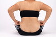 © 4everiswhat - Woman's fingers measuring her belly fat