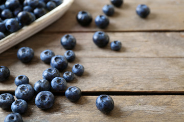 Canvas Print - Tasty ripe blueberries on wooden table close up