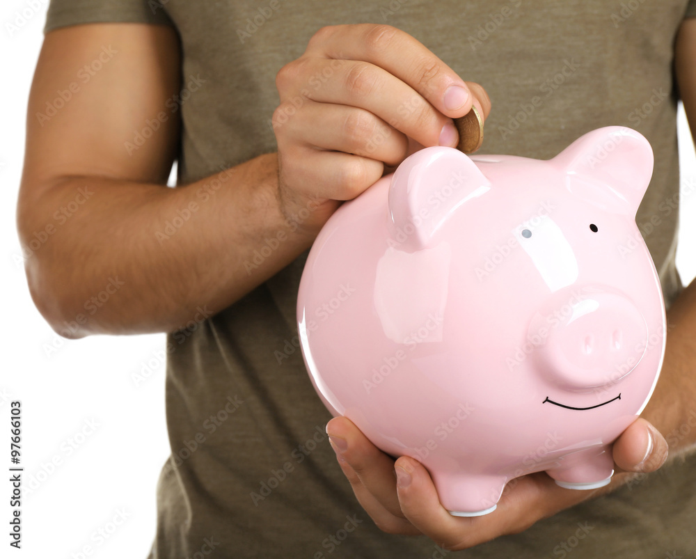 Man put coin into a piggy-bank