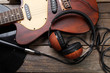 electric guitar headphones on wooden background