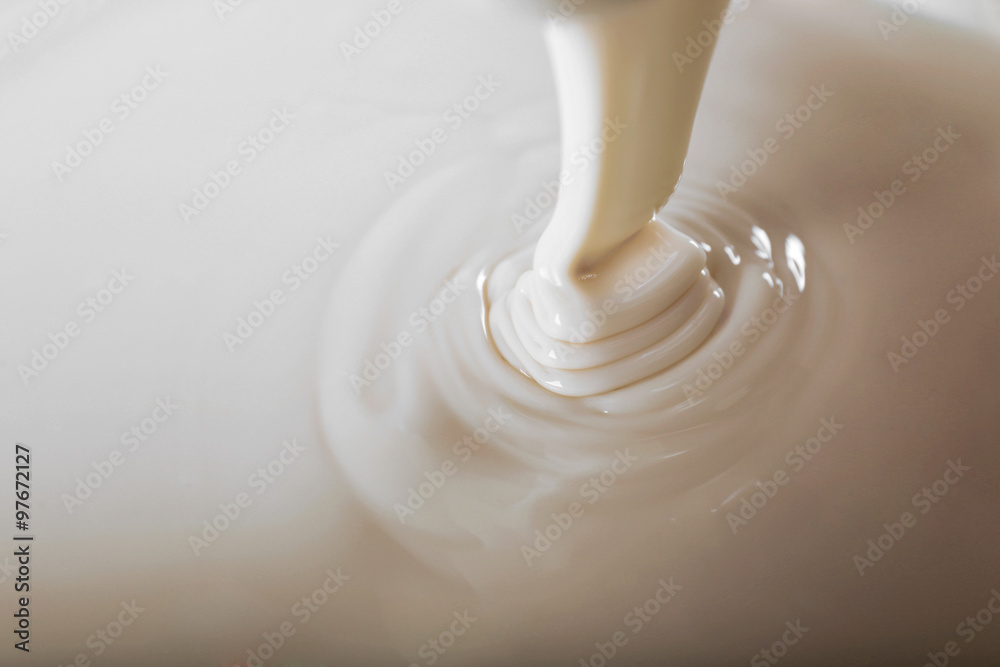 Background of condensed milk in a bowl, close-up