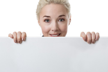 Blonde woman holding a white blank banner.