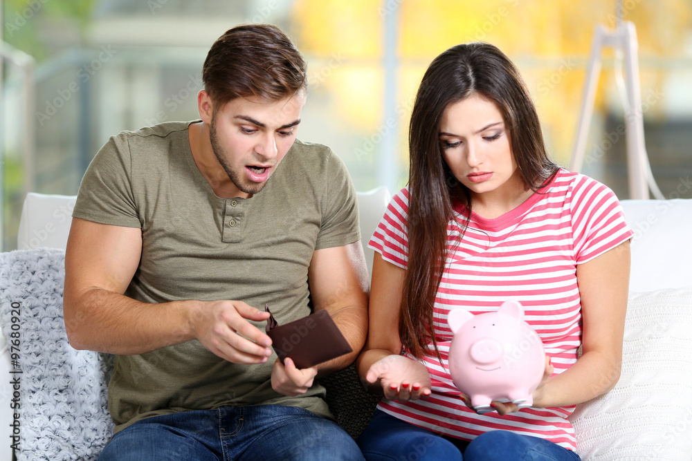 Happy couple counting money from the moneybox