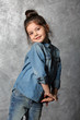© Africa Studio - Portrait of little fashion kid girl on gray wall background