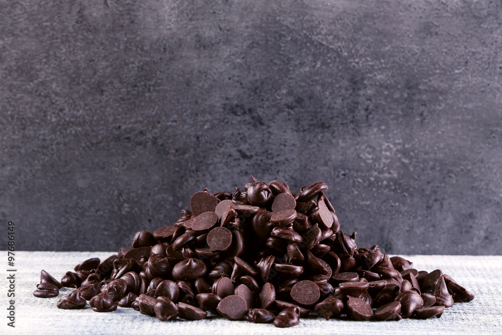 Chocolate morsels on gray background