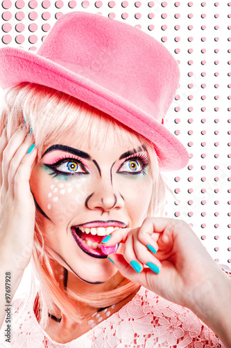 Fototapeta na wymiar Girl with makeup in style pop art is eating hard candy.
