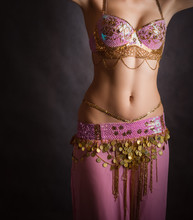 Exotic Belly Dancer Woman With Perfect Body On A Dark Background.