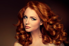 Girl Model With Long Red Wavy Hair. Big Curls On The Red Head . Hairstyle  Permanent Waving