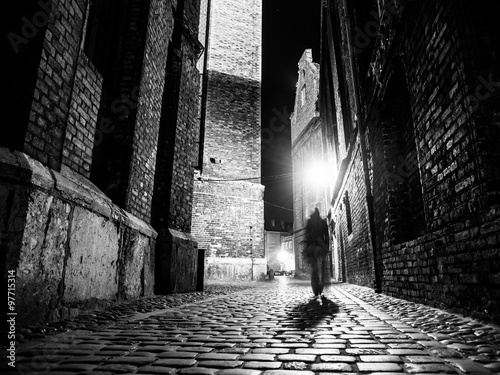 Cuadros en Lienzo Illuminated cobbled street in old city by night