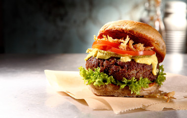 Wall Mural - Tasty rustic burger with a juicy meat patty