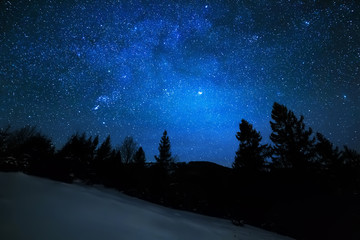 milky way in sky full of stars. winter mountain landscape in night.