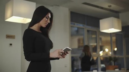 Poster - Business woman standing in the office and talking with a tablet