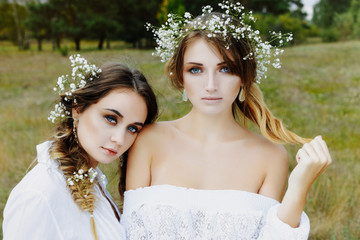 Two women in white dresses