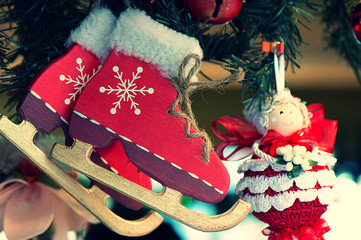 Wooden ice skates hanging from a christmas tree