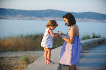 Wall Mural - Mother Holding Daughter's Hands