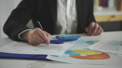 Poster - a man looks at the charts and checks them using a calculator