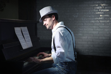 Poster - Handsome young man in hat making piano music