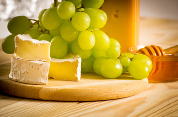 Wall Mural - Still life of cheese, honey and grapes