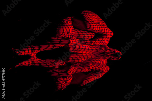 Fényképezés  The  body of woman with red pattern and its reflection